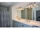 Bright bathroom featuring a double sink vanity, modern lighting, and a large mirror at 3217 New Rutledge Nw Rd, Kennesaw, GA 30152