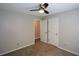 Bedroom featuring neutral paint, carpet, a ceiling fan, and double doors at 3217 New Rutledge Nw Rd, Kennesaw, GA 30152