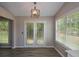 Cozy breakfast nook area featuring a modern light fixture and french doors to the backyard at 3217 New Rutledge Nw Rd, Kennesaw, GA 30152