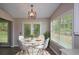 Charming breakfast nook features a round table, bright windows, and a modern light fixture at 3217 New Rutledge Nw Rd, Kennesaw, GA 30152