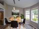 Bright dining room with a modern light fixture and expansive windows overlooking the backyard at 3217 New Rutledge Nw Rd, Kennesaw, GA 30152