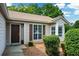 Close-up of the front entrance showcasing the door, windows, and tidy landscaping at 3217 New Rutledge Nw Rd, Kennesaw, GA 30152