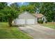 Charming single-story home featuring a two-car garage and a well-maintained front lawn at 3217 New Rutledge Nw Rd, Kennesaw, GA 30152