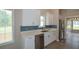 Modern kitchen featuring sleek white cabinets, stainless steel appliances, and a stylish blue backsplash at 3217 New Rutledge Nw Rd, Kennesaw, GA 30152