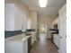 Modern kitchen featuring sleek white cabinets, stainless steel appliances, and a light backsplash at 3217 New Rutledge Nw Rd, Kennesaw, GA 30152
