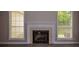 Cozy living room featuring a fireplace and natural light from two windows at 3217 New Rutledge Nw Rd, Kennesaw, GA 30152