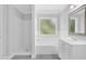 Bright bathroom with a combination tub/shower and a vanity offering efficient use of space at 4002 Laurel Bend Dr, Snellville, GA 30039