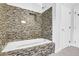 Modern tiled tub with a built-in shower niche, seamlessly blending luxury and functionality at 4002 Laurel Bend Dr, Snellville, GA 30039
