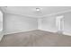 Large bedroom with neutral carpet, trim, and paint, plus bright natural light at 4002 Laurel Bend Dr, Snellville, GA 30039