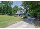 Landscaped home with a large front yard, concrete driveway and inviting front porch at 4002 Laurel Bend Dr, Snellville, GA 30039