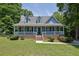 Charming home with a welcoming front porch, dormer windows and mature trees at 4002 Laurel Bend Dr, Snellville, GA 30039