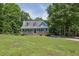 Charming home with a manicured front lawn, dormer windows, and covered porch at 4002 Laurel Bend Dr, Snellville, GA 30039