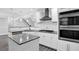 Modern kitchen with stainless appliances, gray granite counters, and subway tile backsplash at 4002 Laurel Bend Dr, Snellville, GA 30039