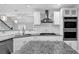 Bright kitchen boasts stainless appliances, granite countertops, and eat-in island at 4002 Laurel Bend Dr, Snellville, GA 30039