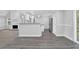 Open-concept living area, connecting the living room and kitchen, with hardwood flooring at 4002 Laurel Bend Dr, Snellville, GA 30039