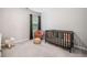Serene Bedroom featuring a crib, rocker, and plush toy at 1347 Elderwood Way, Cumming, GA 30041