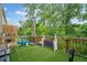 Outdoor deck with artificial grass and various play items at 1347 Elderwood Way, Cumming, GA 30041