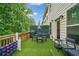 Outdoor deck featuring artificial grass, a grill, and a dining area at 1347 Elderwood Way, Cumming, GA 30041