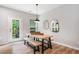 Bright dining area featuring a rustic wooden table with bench seating and access to the outdoor deck at 1347 Elderwood Way, Cumming, GA 30041