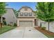 Charming two-story home with a brick facade, a two-car garage, and a well-maintained lawn at 1347 Elderwood Way, Cumming, GA 30041