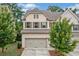Charming two-story home with a brick facade, shutters and a two-car garage at 1347 Elderwood Way, Cumming, GA 30041