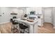 Modern kitchen featuring stainless steel appliances, white cabinets, and a large island with seating at 1347 Elderwood Way, Cumming, GA 30041