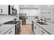 Contemporary kitchen with stainless steel appliances, granite counters, white cabinets, and a gas range at 1347 Elderwood Way, Cumming, GA 30041