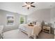 Serene bedroom featuring two large windows, neutral decor, and comfortable furnishings at 1347 Elderwood Way, Cumming, GA 30041