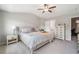 Cozy bedroom with soft carpet, neutral decor, and a ceiling fan for added comfort at 1347 Elderwood Way, Cumming, GA 30041