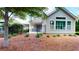 An inviting, fenced backyard with mature trees, landscaping, and a covered patio at 2058 Bonneville Ln, Powder Springs, GA 30127