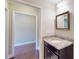 Bathroom featuring granite vanity, framed mirror, neutral walls, and white trim at 2058 Bonneville Ln, Powder Springs, GA 30127