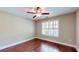 Cozy bedroom featuring hardwood floors, a ceiling fan, and plantation shutters for ample natural light at 2058 Bonneville Ln, Powder Springs, GA 30127