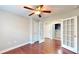 Versatile bedroom features hardwood floors, ceiling fan, and bright french doors with entry to additional rooms at 2058 Bonneville Ln, Powder Springs, GA 30127