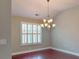An elegant dining room with hardwood floors and a stylish chandelier at 2058 Bonneville Ln, Powder Springs, GA 30127