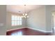 An elegant dining room with hardwood floors and a stylish chandelier at 2058 Bonneville Ln, Powder Springs, GA 30127
