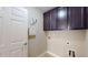 Laundry room with dark cabinets, neutral walls, and washer/dryer hookups at 2058 Bonneville Ln, Powder Springs, GA 30127
