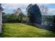 Large grassy backyard enclosed by a wooden fence and a wooded area, offering privacy at 2121 Silva Ct, Conley, GA 30288