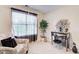 Cozy bedroom featuring a large window, an accent table, and a comfortable chair at 2121 Silva Ct, Conley, GA 30288