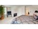 Bright main bedroom with large plant, TV, and ensuite bathroom at 2121 Silva Ct, Conley, GA 30288