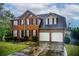 Charming two-story brick home featuring a two-car garage and a well-maintained front lawn at 2121 Silva Ct, Conley, GA 30288