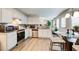 Bright kitchen features white cabinets, stainless steel appliances, and an adjoining breakfast area at 2121 Silva Ct, Conley, GA 30288