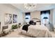 Main bedroom with a chandelier, neutral décor, seating, and natural light at 2121 Silva Ct, Conley, GA 30288