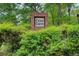 Community entrance sign surrounded by lush greenery, creating an inviting and welcoming atmosphere at 2121 Silva Ct, Conley, GA 30288