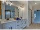Bright bathroom features double sinks, vanity with drawers, and a large mirror over a stone countertop at 220 Nicklaus Cir, Social Circle, GA 30025