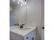 Bathroom featuring a large mirror and a white cabinet with a modern faucet at 220 Nicklaus Cir, Social Circle, GA 30025