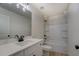 Bathroom featuring a white vanity and black hardware, a tub, and a large mirror at 220 Nicklaus Cir, Social Circle, GA 30025
