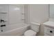 Bathroom featuring a tub with a shower and a white toilet and cabinet at 220 Nicklaus Cir, Social Circle, GA 30025