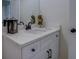 Modern bathroom vanity with white cabinets, countertop, and decorative accents at 220 Nicklaus Cir, Social Circle, GA 30025