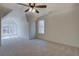 Bright bedroom featuring carpet, a ceiling fan and two windows offering natural light at 220 Nicklaus Cir, Social Circle, GA 30025