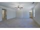 Bright bedroom with plush carpeting, ceiling fan and an ensuite bathroom at 220 Nicklaus Cir, Social Circle, GA 30025